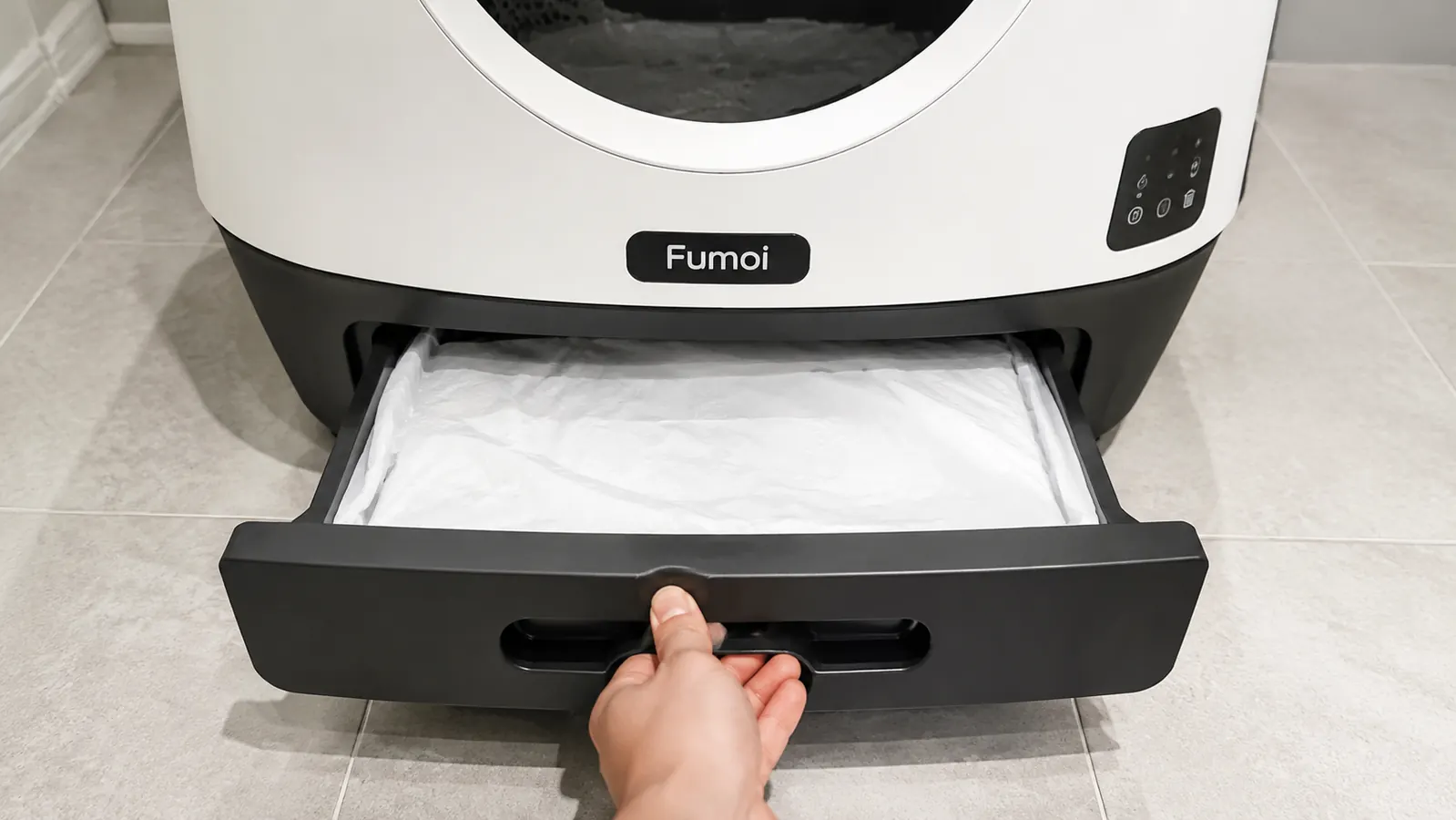 Cat owner emptying the waste drawer of an automatic self-cleaning litter box
